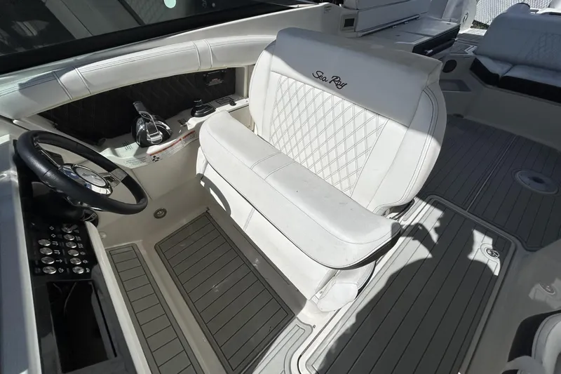 Slide: The Image of 2019 Sea Ray SLX 350 Outboard cockpit with luxurious white seating and modern controls. - 7