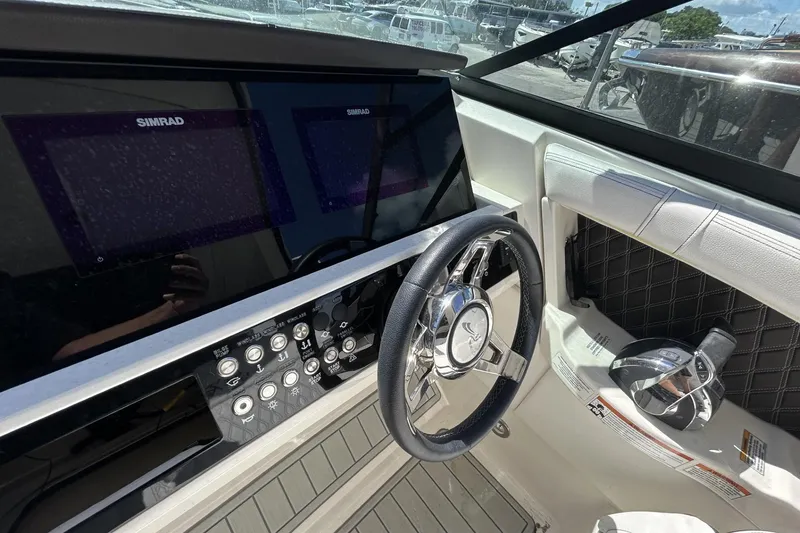 Slide: The Image of 2019 Sea Ray SLX 350 Outboard helm with Simrad displays and modern controls. - 8