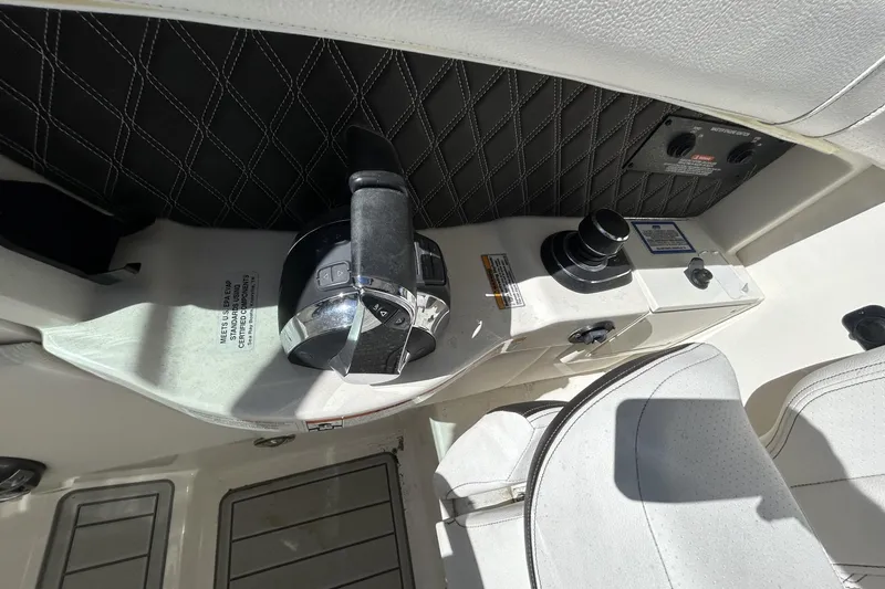 Slide: The Image of 2019 Sea Ray SLX 350 Outboard cockpit controls with leather accents and modern design. - 9