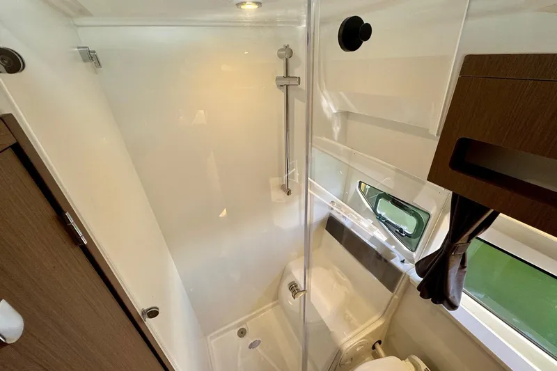 Slide: The Image of 2024 Beneteau Antares 11 bathroom with modern shower and window view. - 13