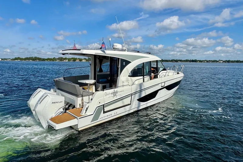 Slide: The Image of 2024 Beneteau Antares 11 cruising on open water under a partly cloudy sky. - 17