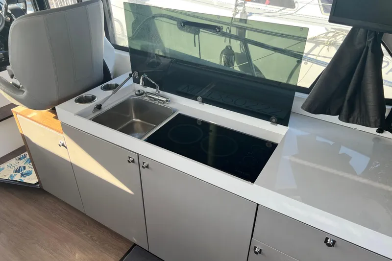 Slide: The Image of 2024 Beneteau Antares 11 helm with modern navigation controls and steering wheel. - 23