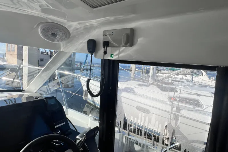 Slide: The Image of 2024 Beneteau Antares 11 interior with wood paneling and control panels. - 25