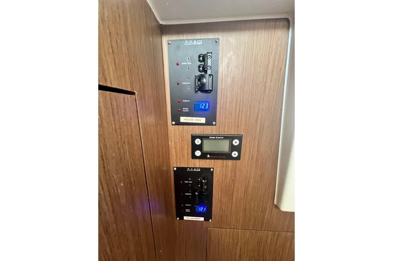 Slide: The Image of 2024 Beneteau Antares 11 bathroom with modern fixtures and wood cabinetry. - 27