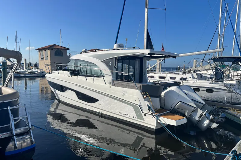 Slide: The Image of 2024 Beneteau Antares 11 cruising on a sunny day with twin outboard engines. - 6