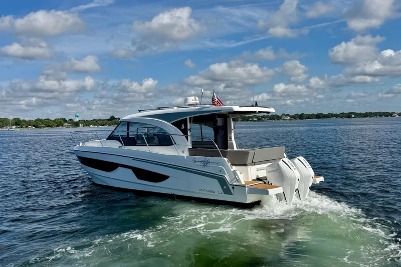 Slide: The Image of 2024 Beneteau Antares 11 yacht docked in a marina under clear blue skies. - 7