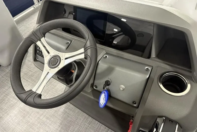 Slide: The Image of Steering console of 2026 Sun Tracker SportFish 20 DLX boat with modern controls. - 18