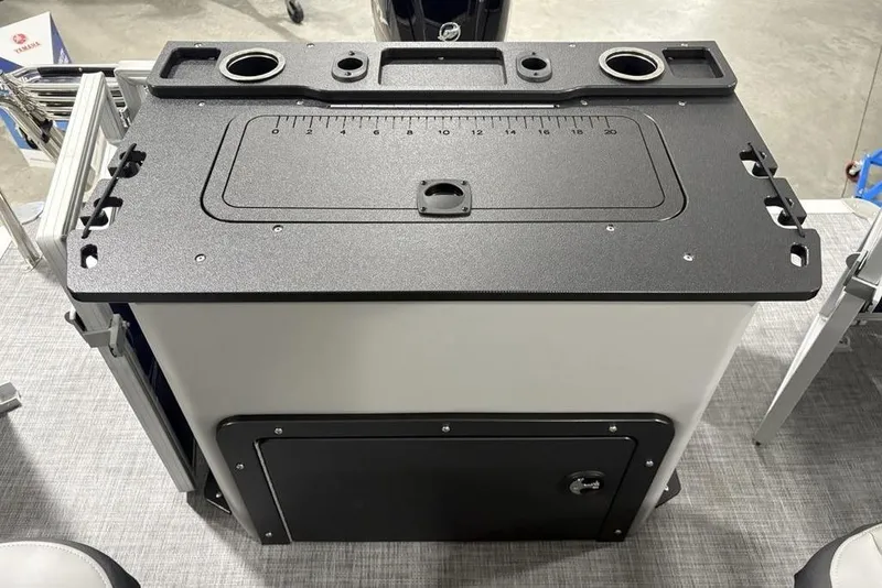 Slide: The Image of 2026 Sun Tracker SportFish 20 DLX fishing station with built-in measuring board and cup holders. - 29