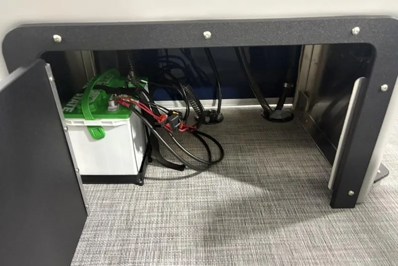 Slide: The Image of Battery compartment of 2026 Sun Tracker SportFish 20 DLX boat, showing wiring and connections. - 33