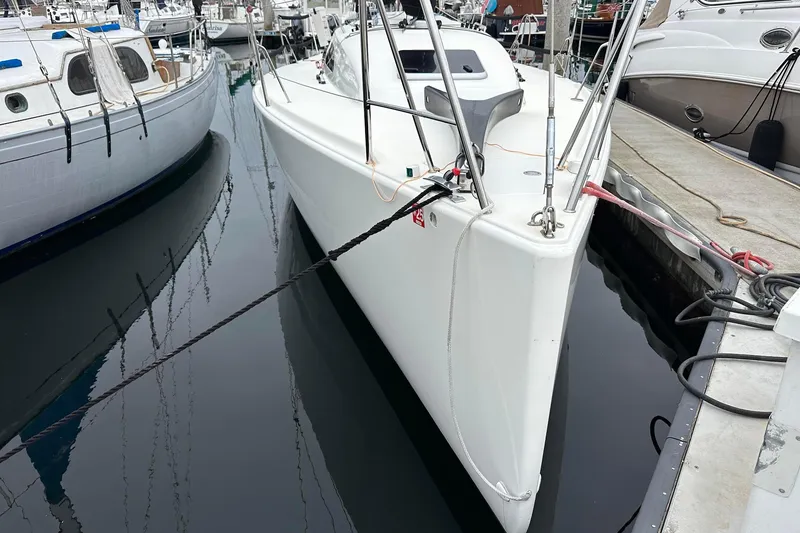 Slide: The Image of 2021 J Boats J99 sailboat docked in marina, surrounded by other vessels. - 1