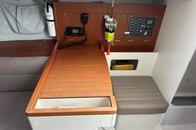 Slide: The Image of 2021 J Boats J99 interior navigation station with communication equipment and control panel. - 16