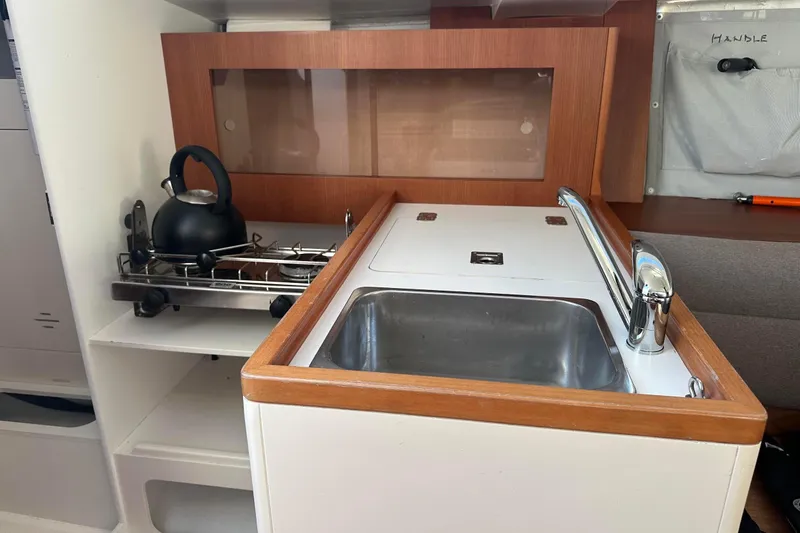 Slide: The Image of 2021 J Boats J/99 yacht galley with sink, stove, and kettle. - 18