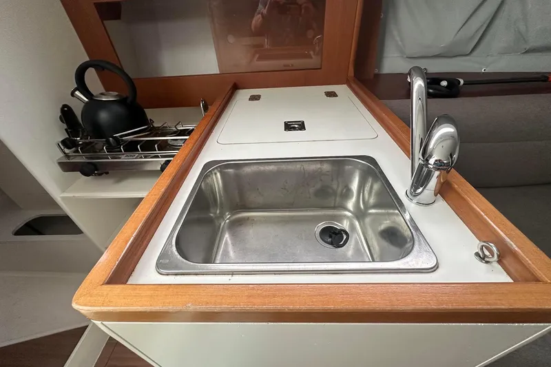 Slide: The Image of Compact galley with sink and stove in 2021 J Boats J99 sailboat interior. - 19
