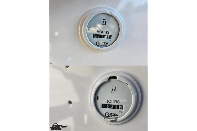 Slide: The Image of Hour meters on a 2002 Hustler 388 SLINGSHOT, showing usage hours. - 100