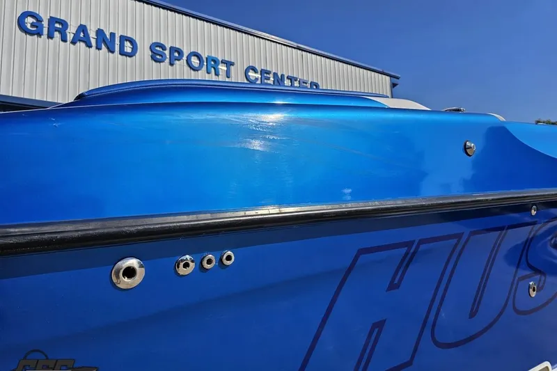 Slide: The Image of Blue 2002 Hustler 388 SLINGSHOT boat at Grand Sport Center, side view. - 11
