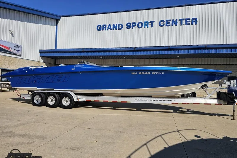 Slide: The Image of 2002 Hustler 388 SLINGSHOT boat on trailer at Grand Sport Center. - 12