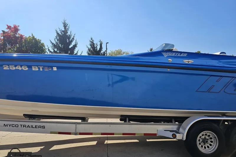 Slide: The Image of Blue 2002 Hustler 388 SLINGSHOT boat on trailer, side view. - 25