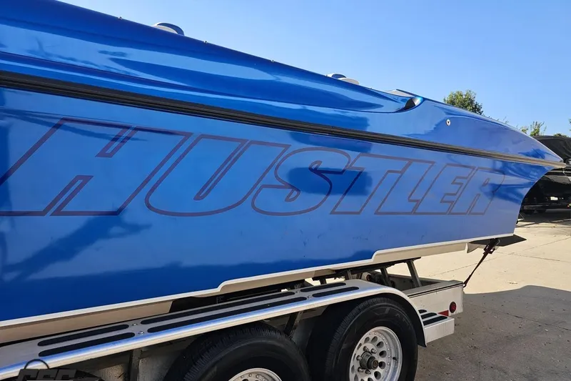 Slide: The Image of Blue 2002 Hustler 388 SLINGSHOT boat on trailer, side view. - 27