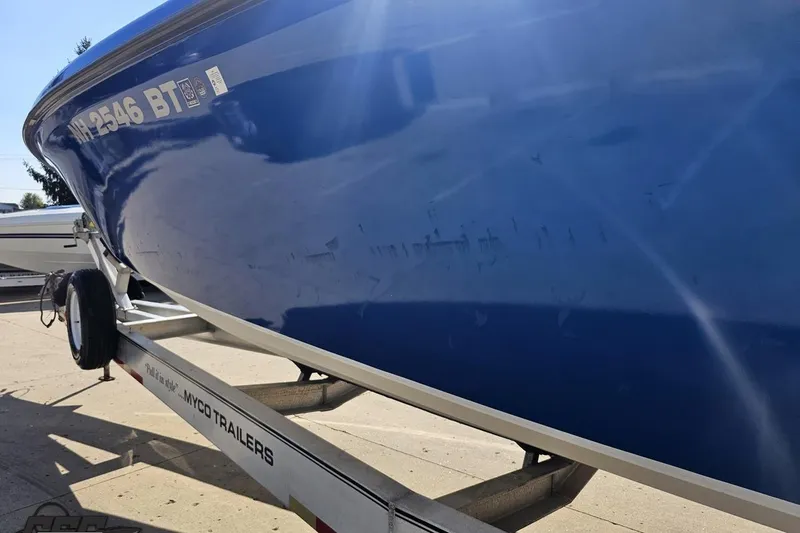 Slide: The Image of Blue 2002 Hustler 388 SLINGSHOT boat on trailer, side view. - 29