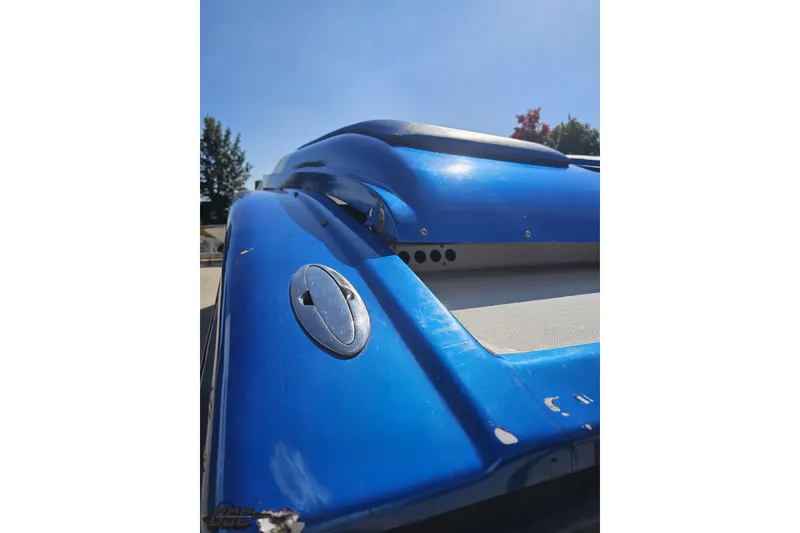 Slide: The Image of Close-up of a blue 2002 Hustler 388 SLINGSHOT boat, showcasing sleek design details. - 39