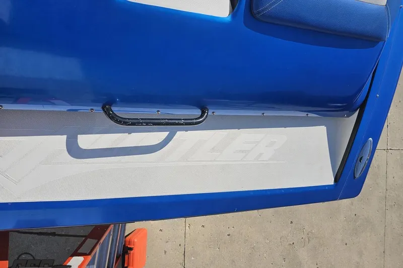 Slide: The Image of Blue 2002 Hustler 388 SLINGSHOT boat interior with handle and logo. - 41