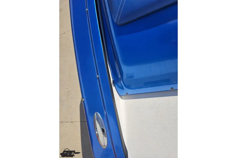 Slide: The Image of Close-up of a 2002 Hustler 388 SLINGSHOT boat in vibrant blue. - 47