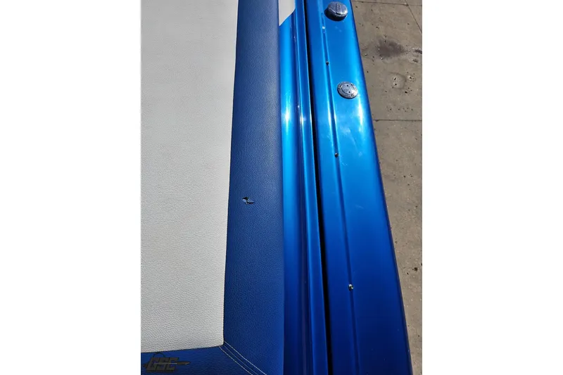 Slide: The Image of Close-up of 2002 Hustler 388 SLINGSHOT boat, featuring blue and white detailing. - 48