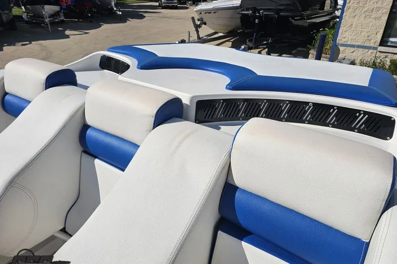 Slide: The Image of 2002 Hustler 388 SLINGSHOT boat interior with blue and white seating. - 51