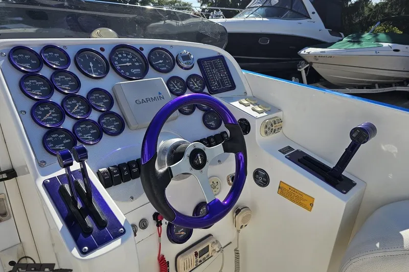Slide: The Image of Cockpit of 2002 Hustler 388 SLINGSHOT with Garmin navigation and purple accents. - 56