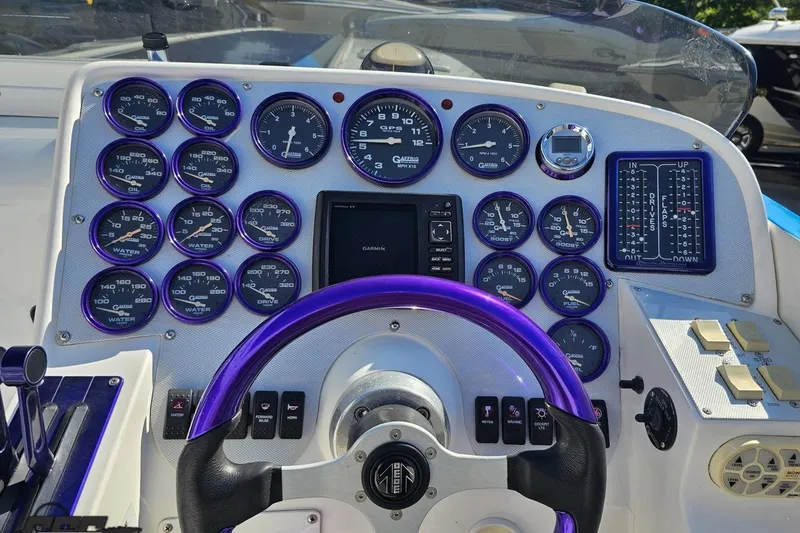 Slide: The Image of Dashboard of a 2002 Hustler 388 SLINGSHOT boat with gauges and controls. - 58