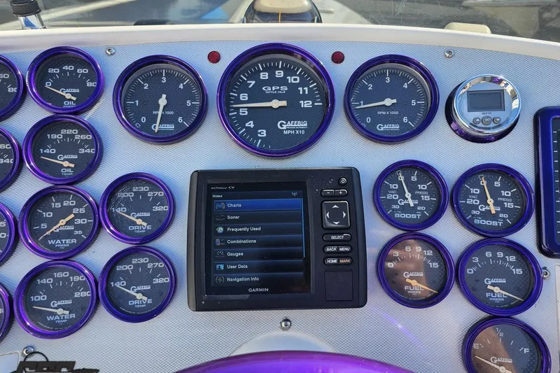 Slide: The Image of Dashboard of a 2002 Hustler 388 SLINGSHOT with gauges and Garmin display. - 59