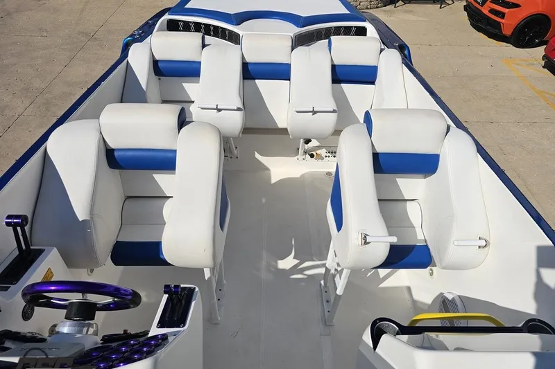 Slide: The Image of Interior of 2002 Hustler 388 SLINGSHOT boat with white and blue seating. - 64