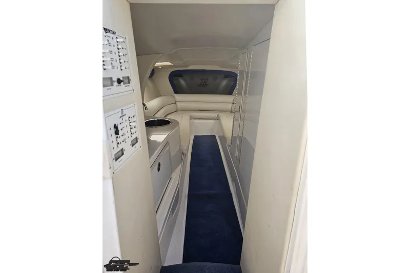 Slide: The Image of Interior of 2002 Hustler 388 SLINGSHOT boat with white seating and blue carpet. - 66