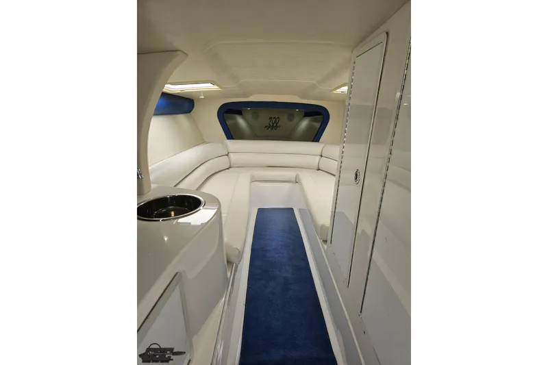 Slide: The Image of Interior of 2002 Hustler 388 SLINGSHOT boat with white seating and blue carpet. - 68