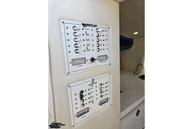 Slide: The Image of Control panel of 2002 Hustler 388 SLINGSHOT boat, featuring switches and meters. - 69
