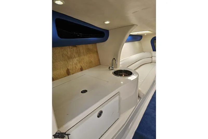 Slide: The Image of Interior of 2002 Hustler 388 SLINGSHOT boat with sink and seating area. - 70