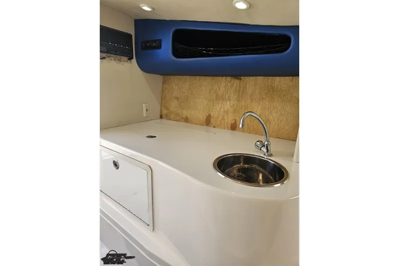 Slide: The Image of Interior of 2002 Hustler 388 SLINGSHOT boat with sink and storage compartment. - 71