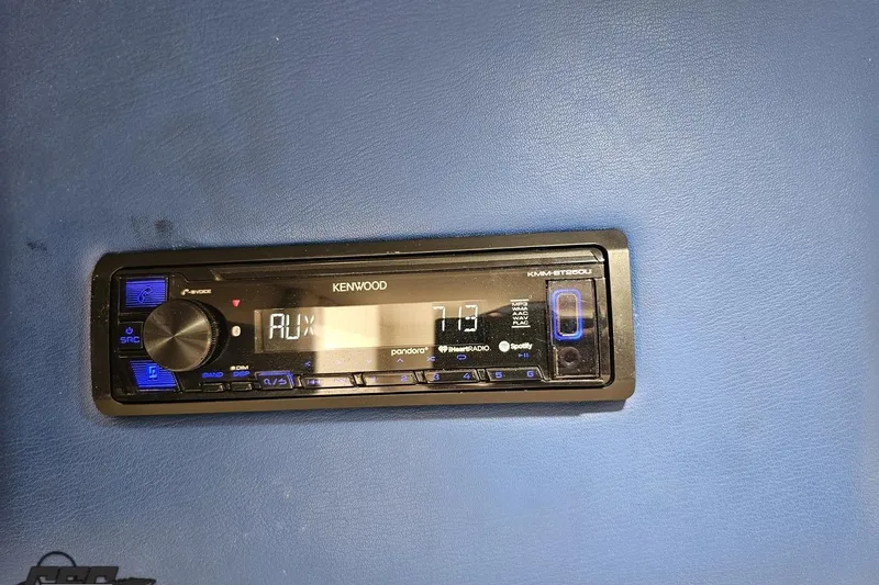 Slide: The Image of Kenwood car stereo in a 2002 Hustler 388 SLINGSHOT, displaying AUX mode. - 72
