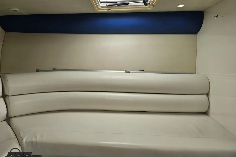 Slide: The Image of Interior of 2002 Hustler 388 SLINGSHOT boat with white leather seating. - 77