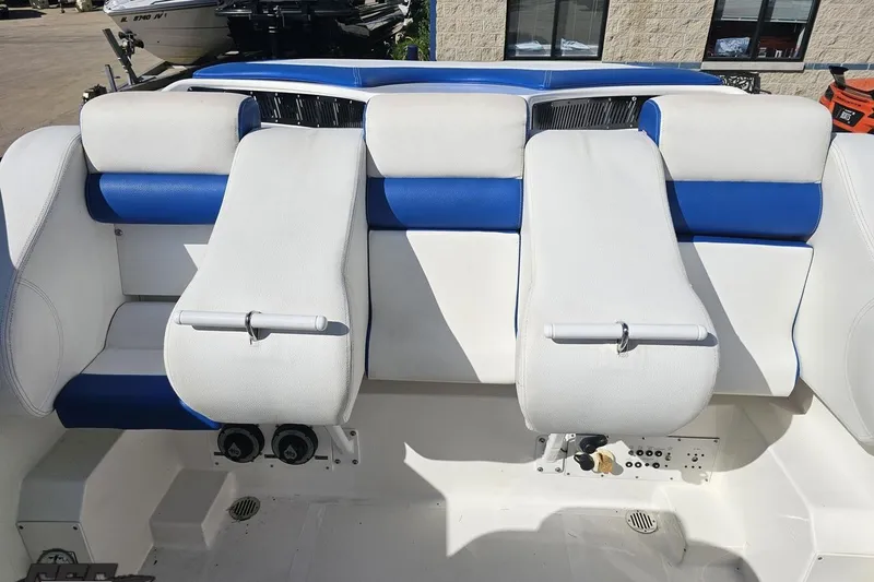 Slide: The Image of 2002 Hustler 388 SLINGSHOT boat interior with white and blue seating. - 87