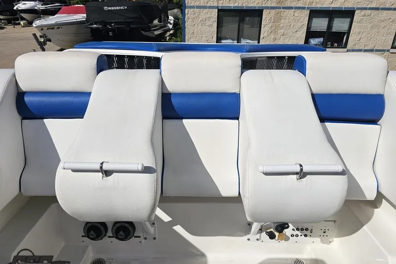 Slide: The Image of 2002 Hustler 388 SLINGSHOT boat interior with white and blue seating. - 89
