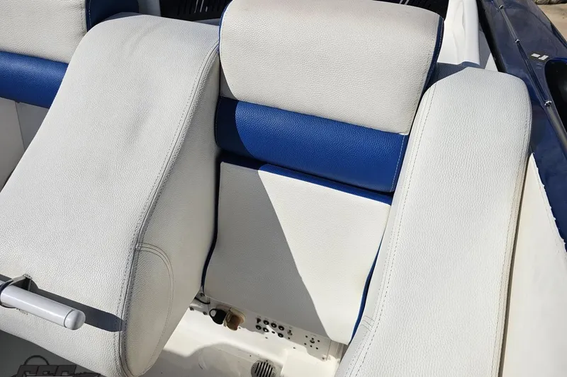 Slide: The Image of 2002 Hustler 388 SLINGSHOT boat interior with white and blue leather seats. - 93