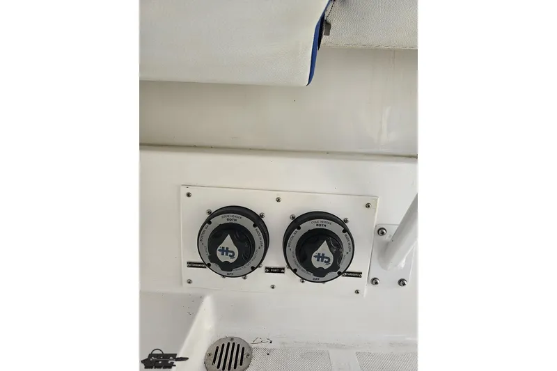 Slide: The Image of Control panel of a 2002 Hustler 388 SLINGSHOT boat, featuring dual switches. - 94