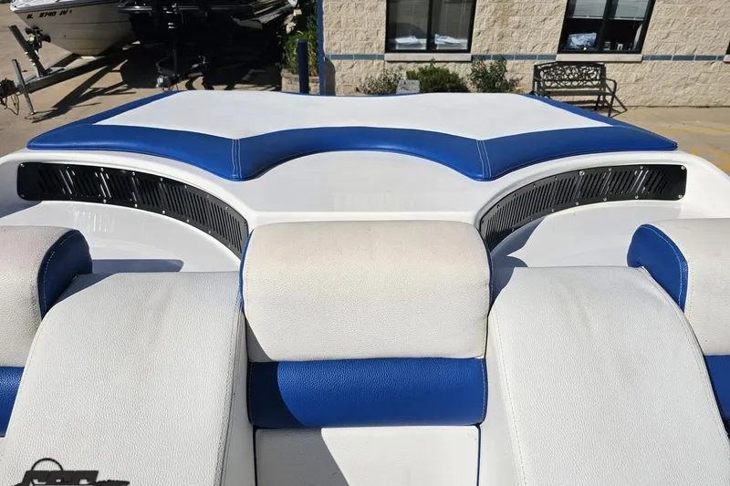 Slide: The Image of 2002 Hustler 388 SLINGSHOT boat interior with blue and white seating. - 96