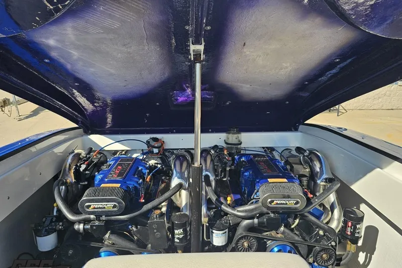 Slide: The Image of Engine compartment of a 2002 Hustler 388 SLINGSHOT with dual Mercury engines. - 97
