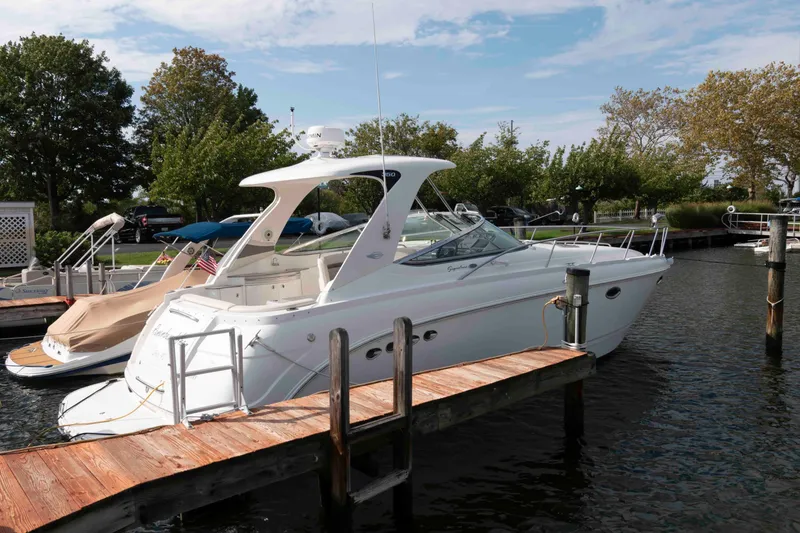 The Image of 2007 Chaparral Signature 350 boat docked at marina, surrounded by trees and calm water. - 0