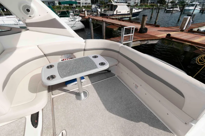 Slide: The Image of 2007 Chaparral Signature 350 boat interior with seating and table, docked at marina. - 10
