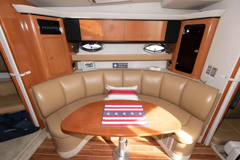 Slide: The Image of 2007 Chaparral Signature 350 interior with tan leather seating and wooden table. - 13