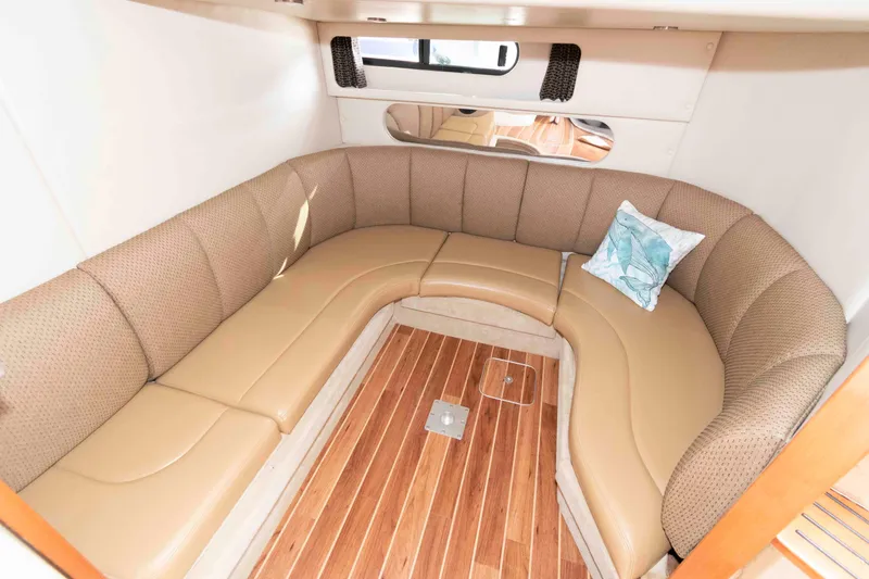 Slide: The Image of 2007 Chaparral Signature 350 interior with curved seating and wooden flooring. - 15