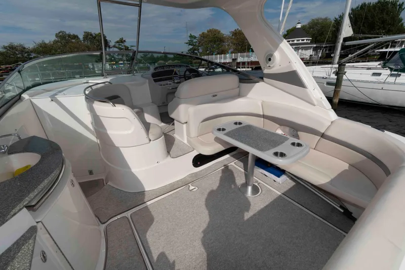 Slide: The Image of 2007 Chaparral Signature 350 boat interior with seating and table, docked at marina. - 3